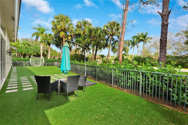 a view of a chair and table in the garden