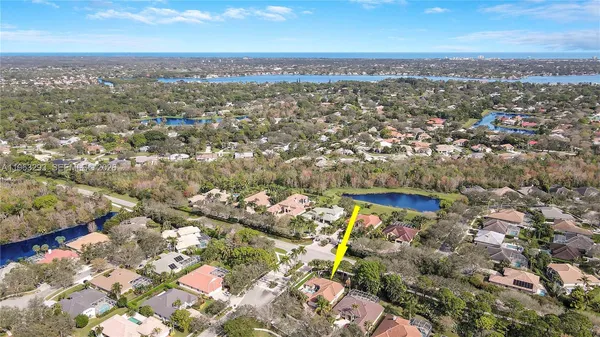 an aerial view of residential building with yard