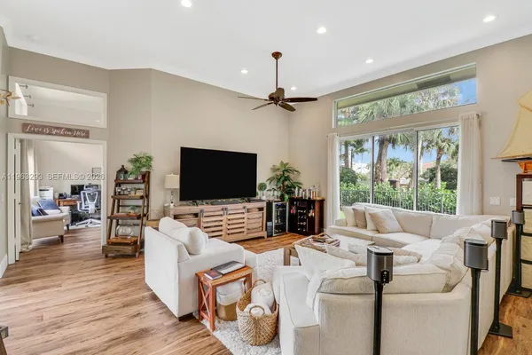a living room with furniture a large window and a flat screen tv