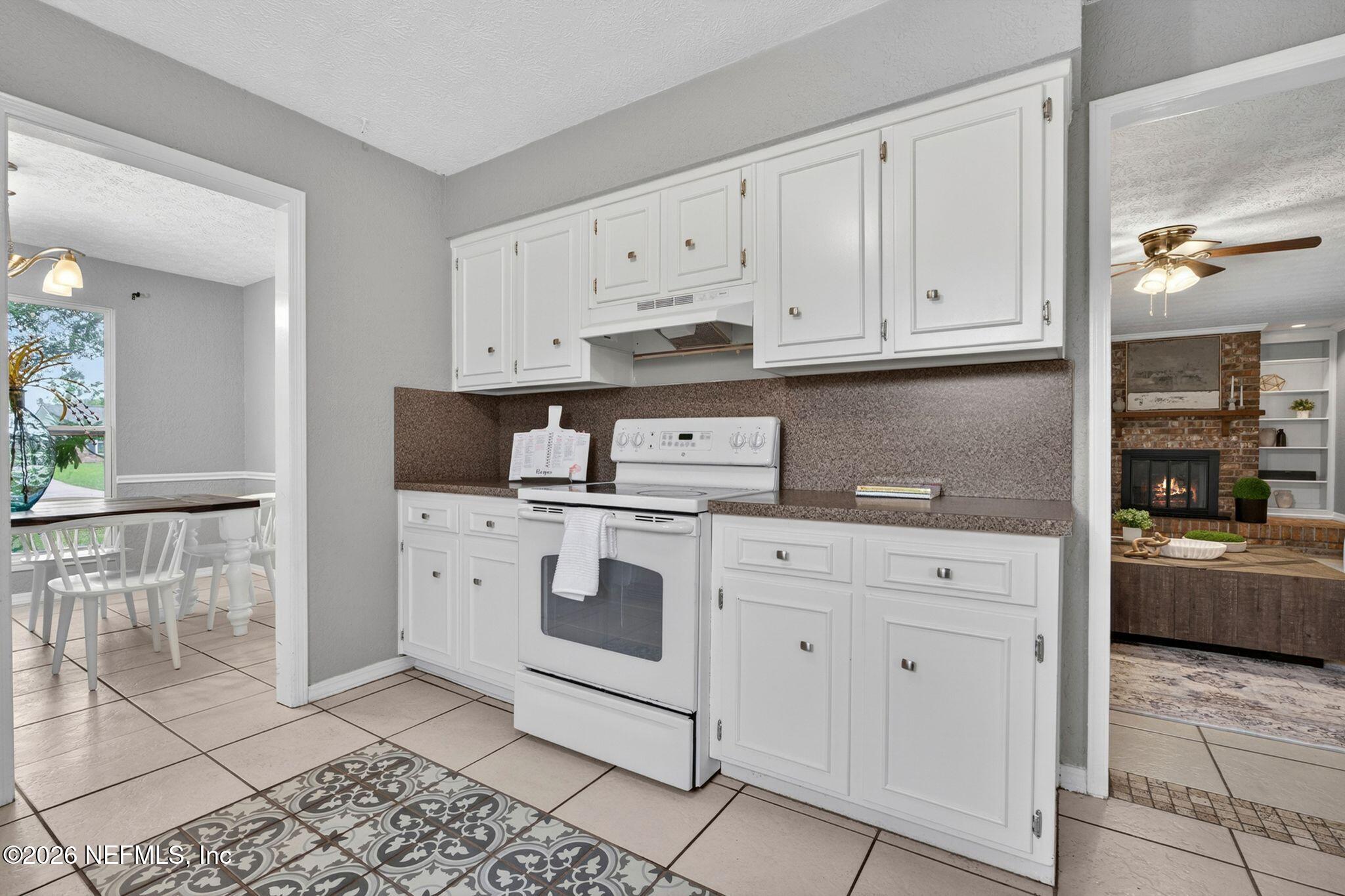 138 Ridgefield Court Orange Park, FL 32065 - Photo 21 of 64 a kitchen with white cabinets and appliances