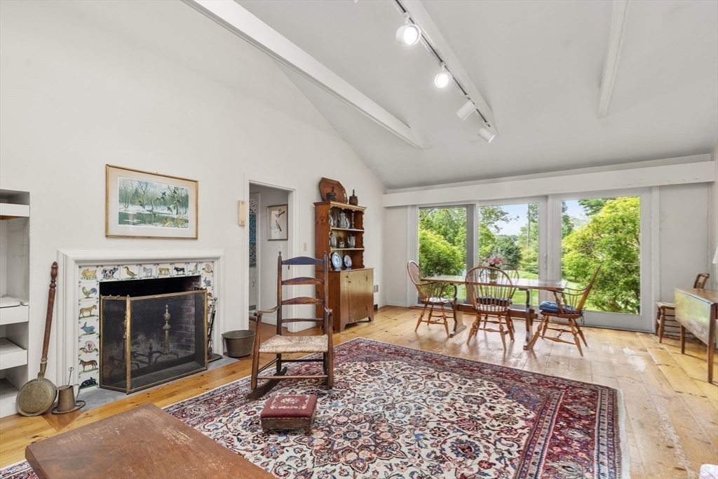 3 Proctor Street Manchester, MA 01944 - Photo 19 of 41 a living room with furniture a rug a fireplace and a large window