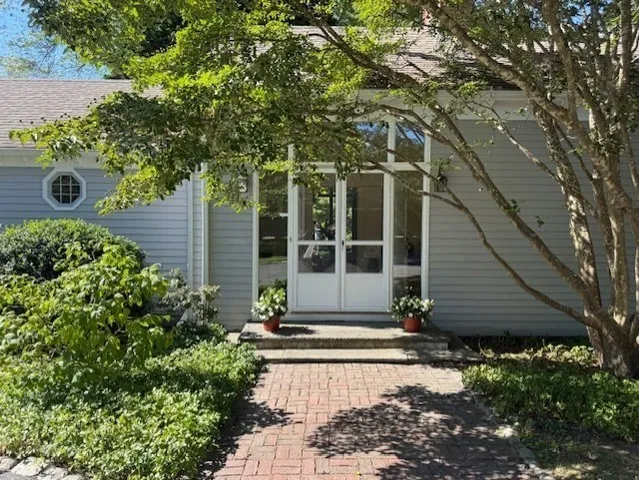 a front view of a house with garden