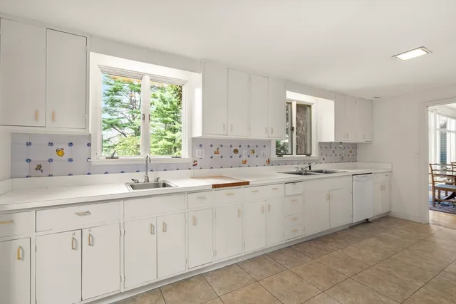 a kitchen with sink cabinets and window