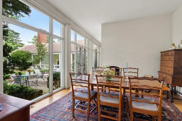 a dining room with furniture and wooden floor