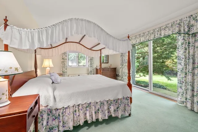 a bedroom with a large bed and a large window