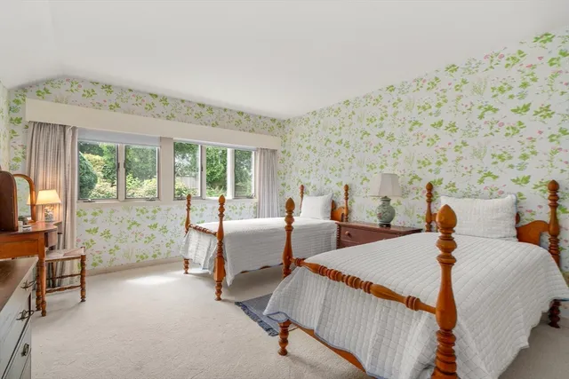 a bed room with a bed and a chair