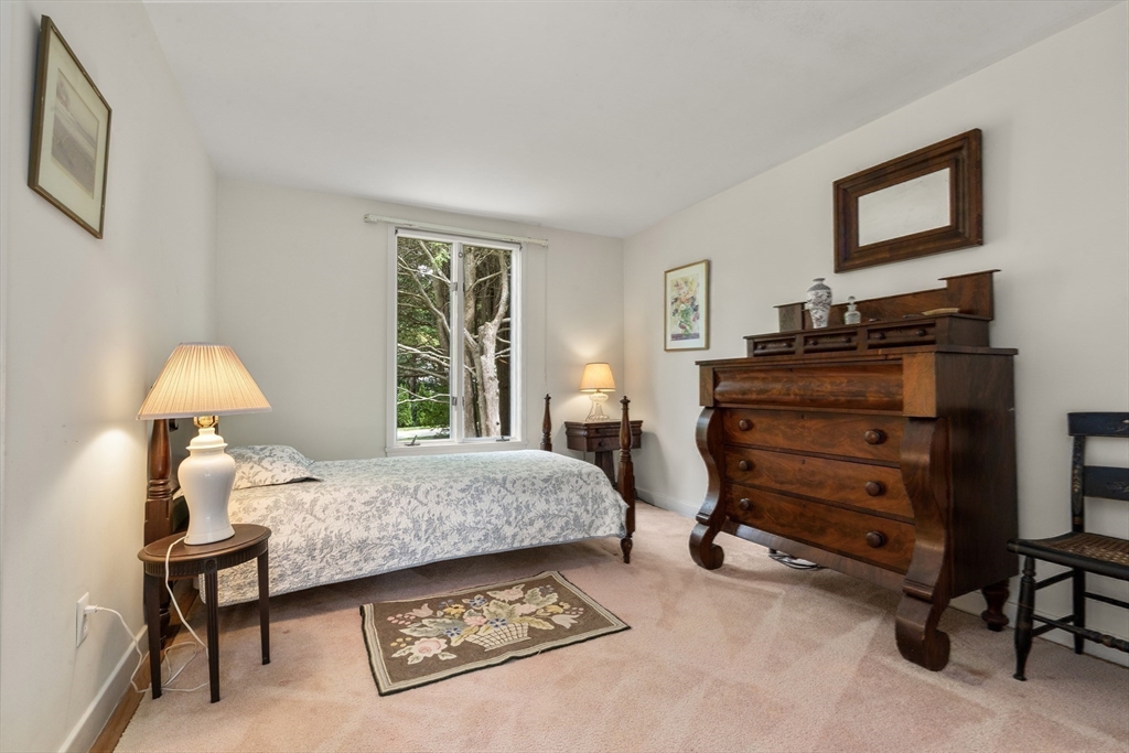 3 Proctor Street Manchester, MA 01944 - Photo 31 of 41 a bedroom with a bed and a table in it