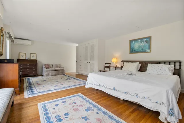 a spacious bedroom with a bed and a couch