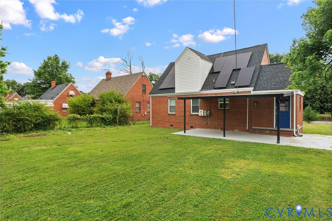 3424 Danbury Road Richmond, VA 23234 - Photo 35 of 37 Back of house featuring roof mounted solar panels,