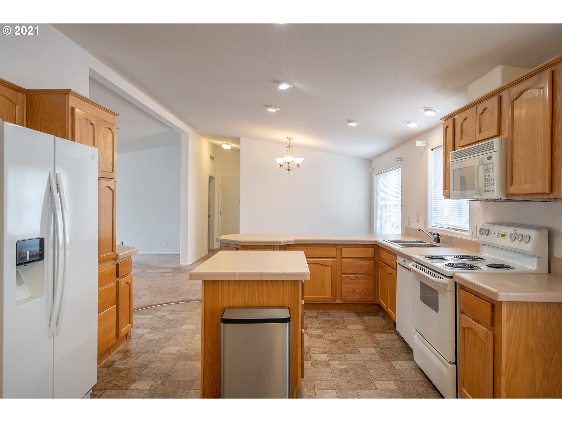 2525 Maia Loop Springfield, OR 97477 - Photo 12 of 27 a kitchen with a sink stove and refrigerator
