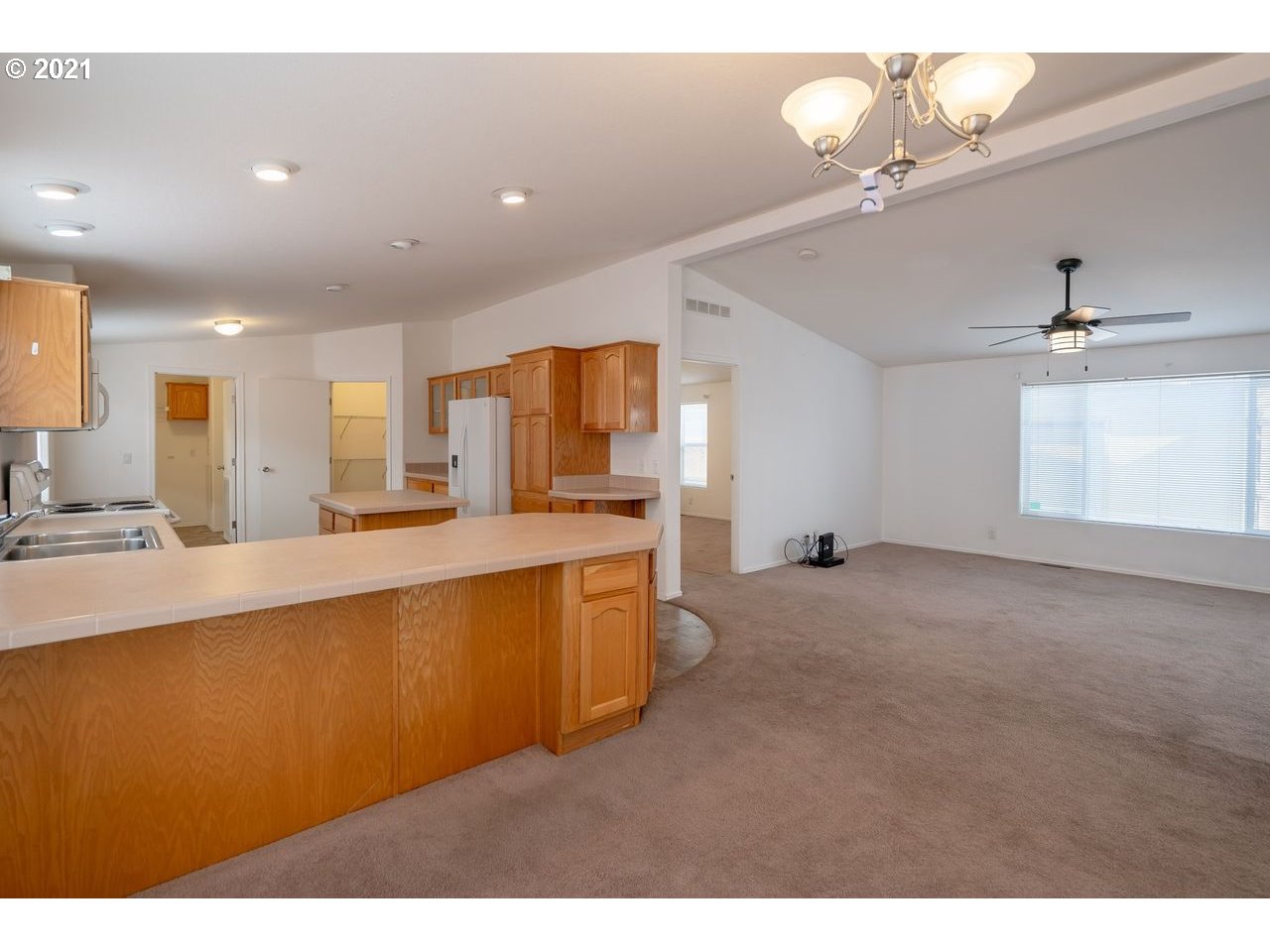 2525 Maia Loop Springfield, OR 97477 - Photo 5 of 27 a large kitchen with kitchen island a sink stainless steel appliances and cabinets