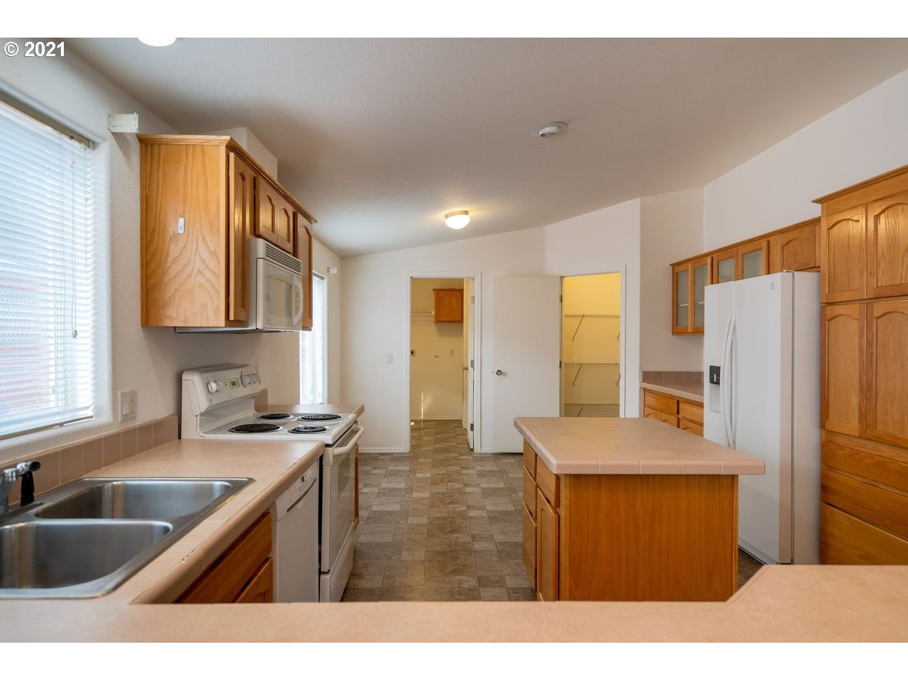 2525 Maia Loop Springfield, OR 97477 - Photo 9 of 27 a kitchen with stainless steel appliances granite countertop a sink refrigerator and cabinets