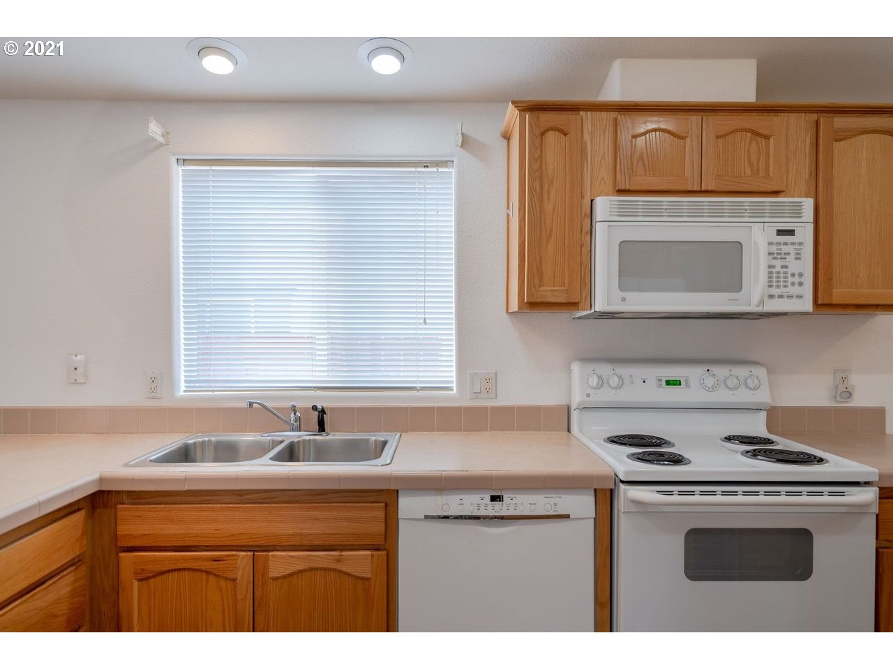 2525 Maia Loop Springfield, OR 97477 - Photo 10 of 27 a kitchen with a sink stove top oven and microwave