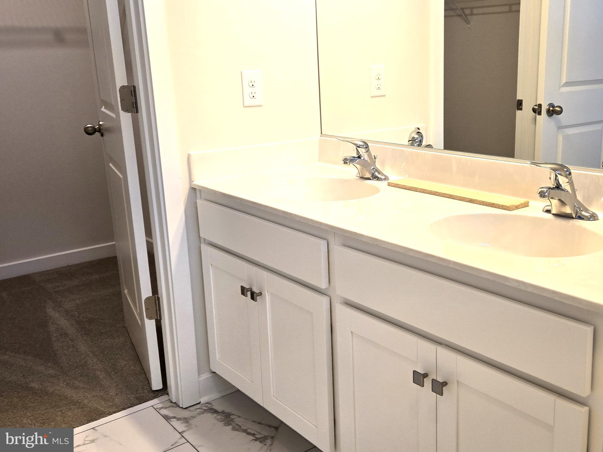 123 Case Road Townsend, DE 19734 - Photo 13 of 22 a bathroom with a double vanity sink and a mirror