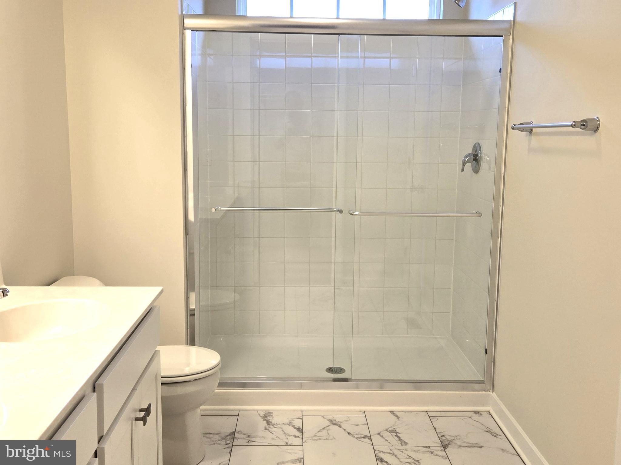 123 Case Road Townsend, DE 19734 - Photo 14 of 22 a bathroom with a shower a toilet and a sink