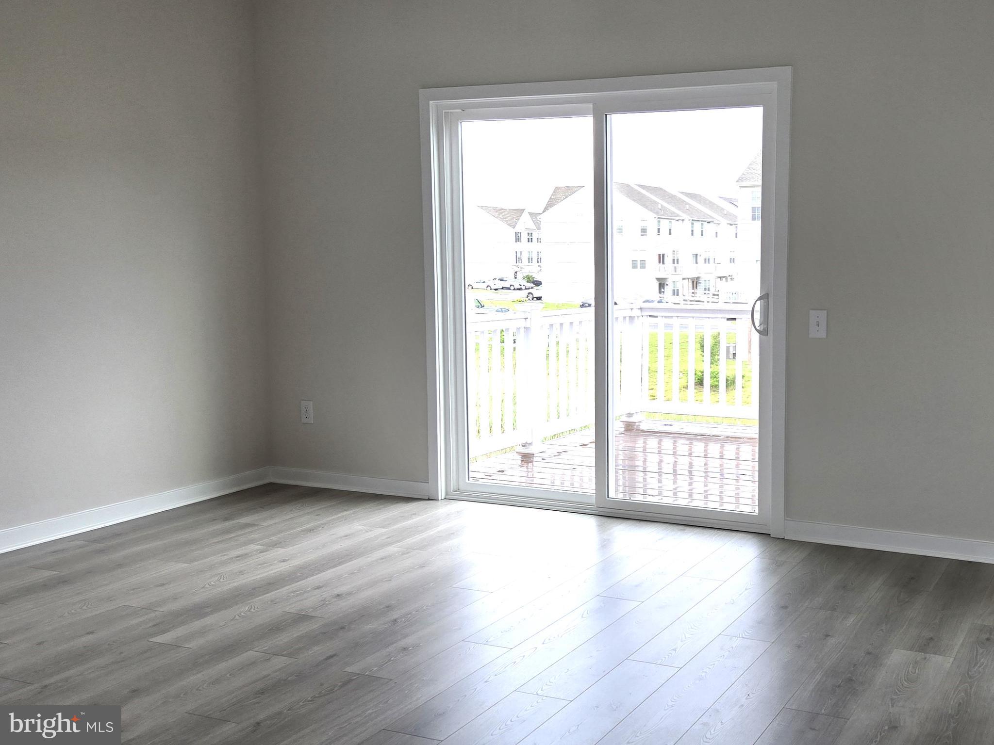 123 Case Road Townsend, DE 19734 - Photo 7 of 22 an empty room with wooden floor and windows