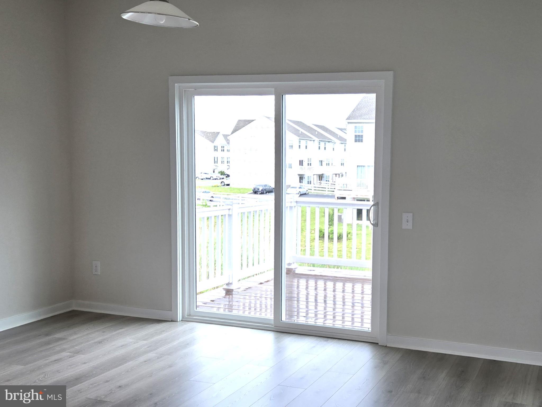 123 Case Road Townsend, DE 19734 - Photo 8 of 22 a view of an empty room with wooden floor and a window