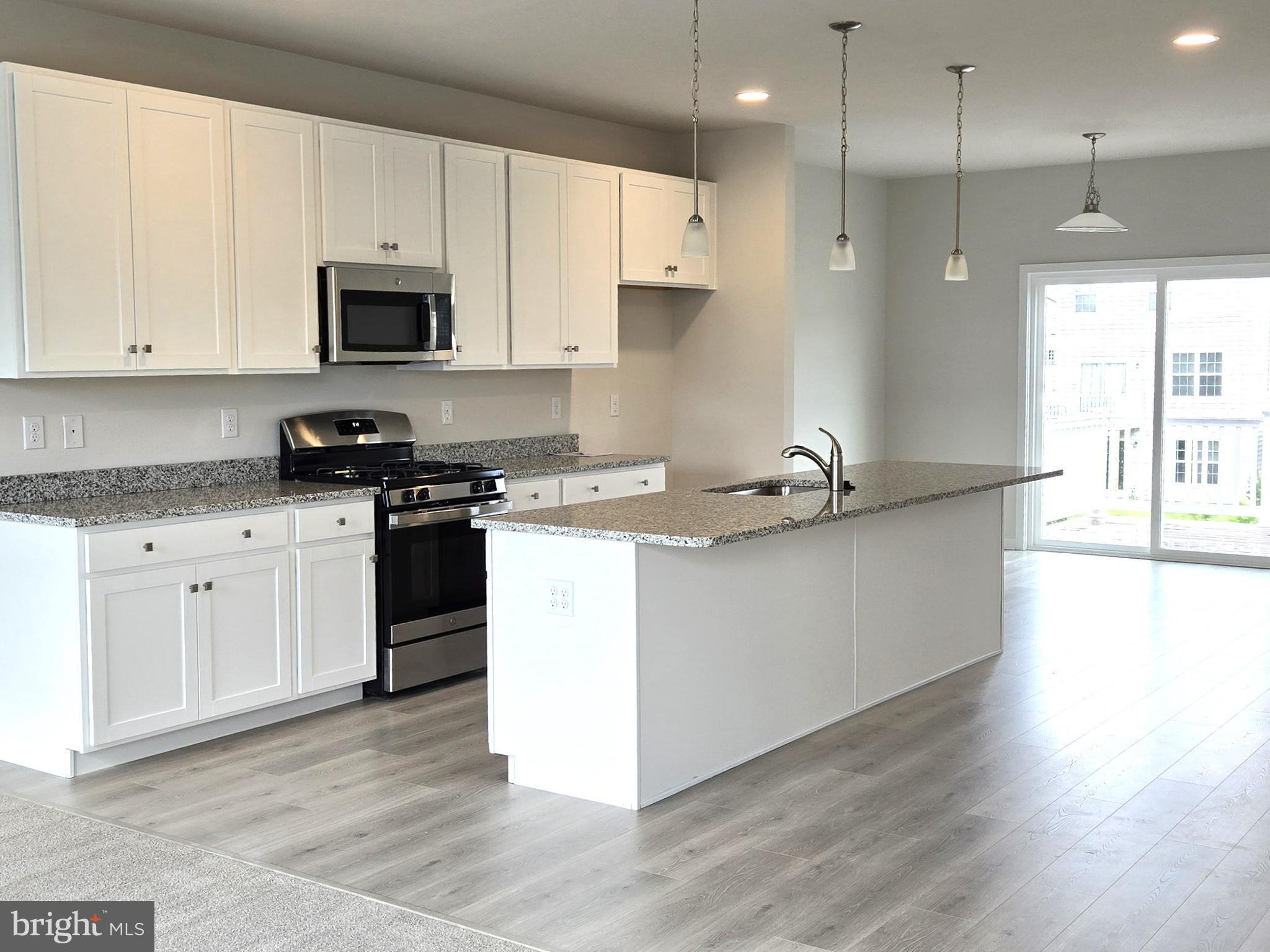 123 Case Road Townsend, DE 19734 - Photo 10 of 22 a kitchen with stainless steel appliances granite countertop a stove a sink and white cabinets