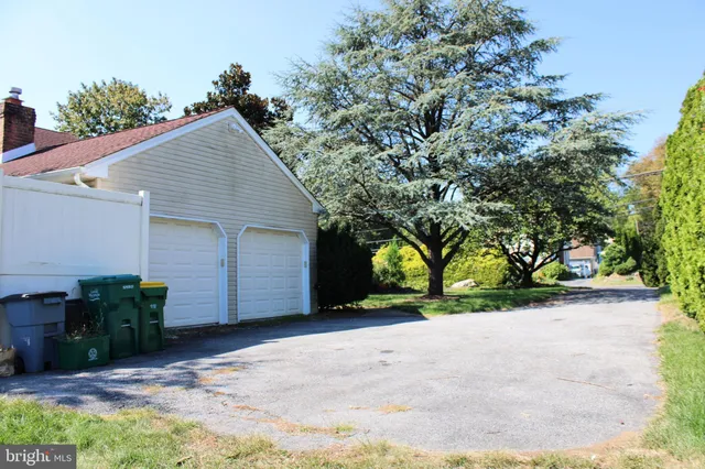 a view of a house with a yard and potted plants