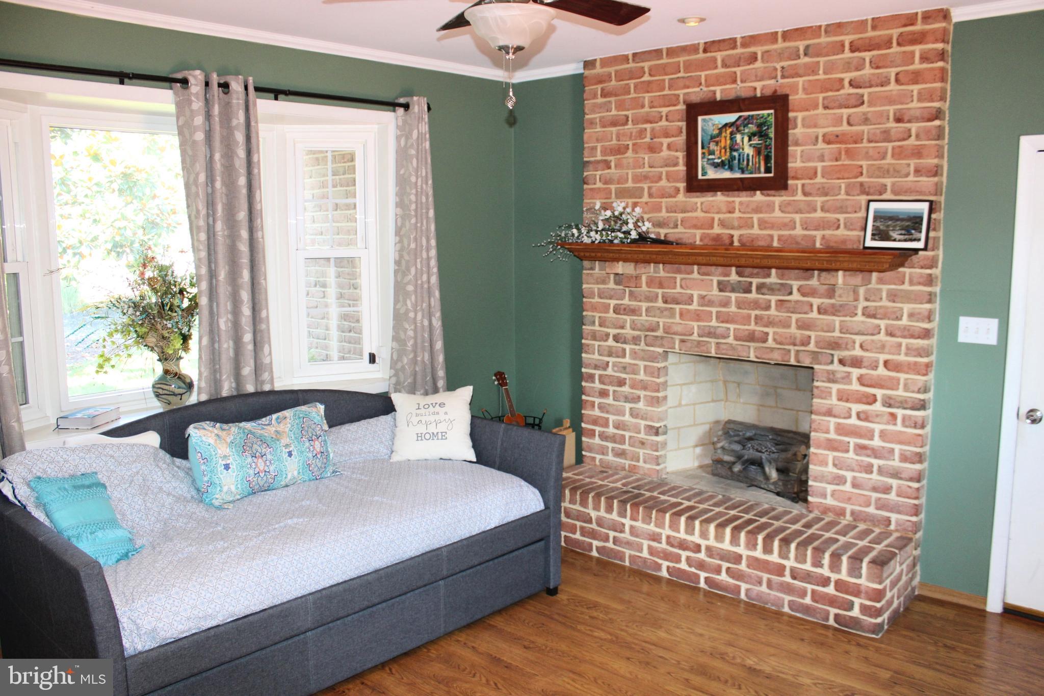 1385 North Brookside Road Allentown, PA 18106 - Photo 6 of 18 a bedroom with a bed and a fireplace