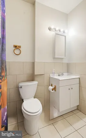 a bathroom with a toilet sink and mirror
