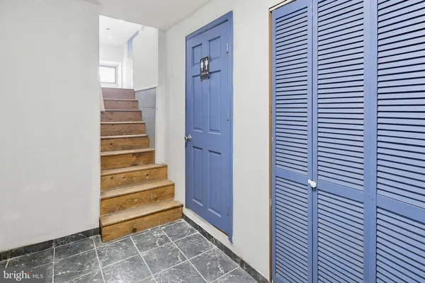 a view of a room with stairs and a window