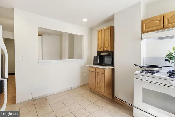 a kitchen with white cabinets and appliances