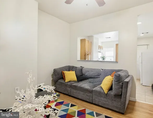 a living room with furniture and painting on the wall