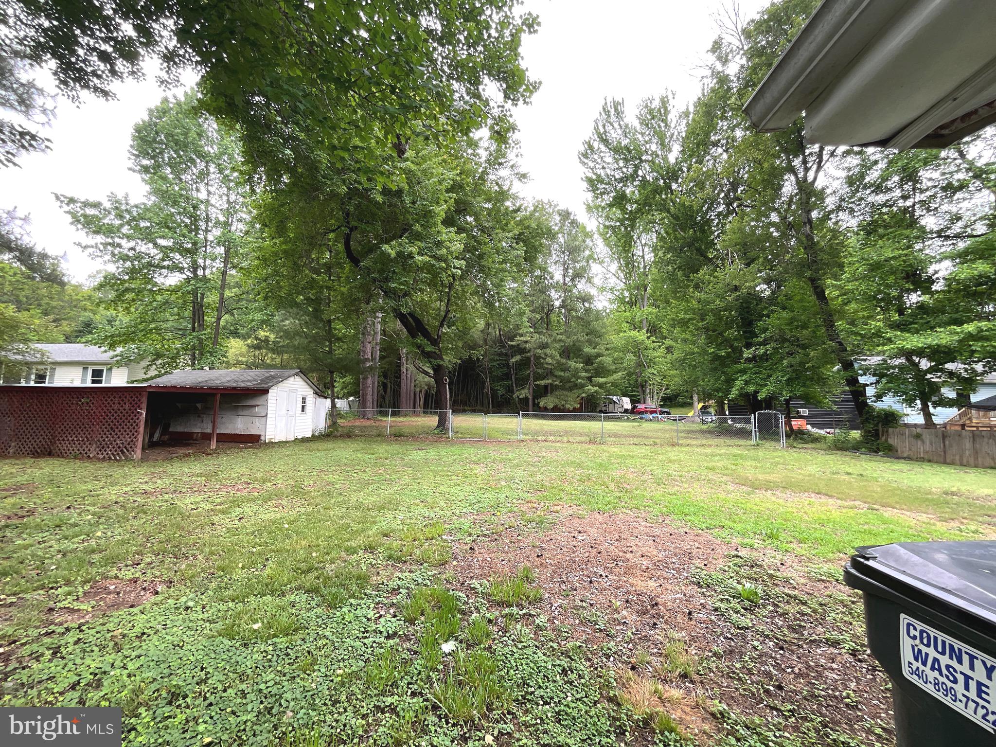 86 Kelley Road Fredericksburg, VA 22405 - Photo 32 of 36 a backyard of a house with trees and entertaining space