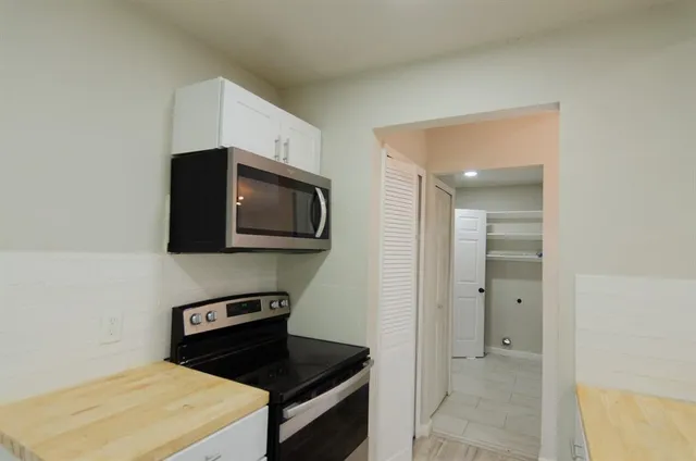 a kitchen with a stove and a microwave