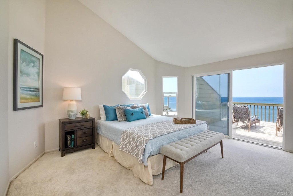 1808 Parliament Road Encinitas, CA 92024 - Photo 21 of 49 a bedroom with a bed and a lamp next to a window