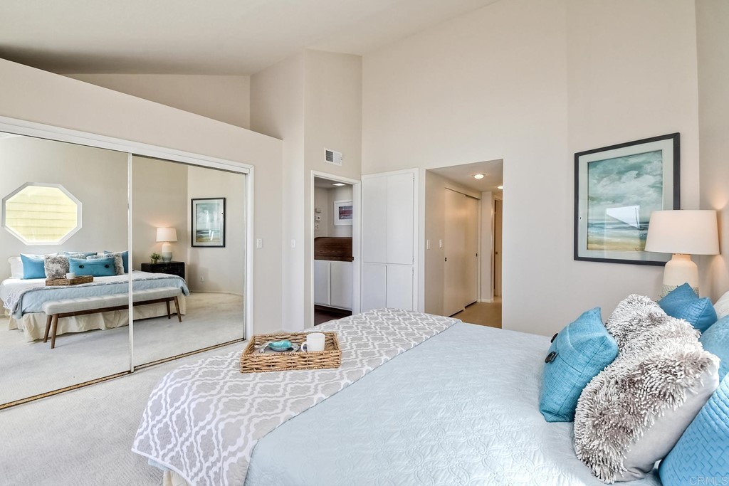 1808 Parliament Road Encinitas, CA 92024 - Photo 23 of 49 a bedroom with bed and a large mirror