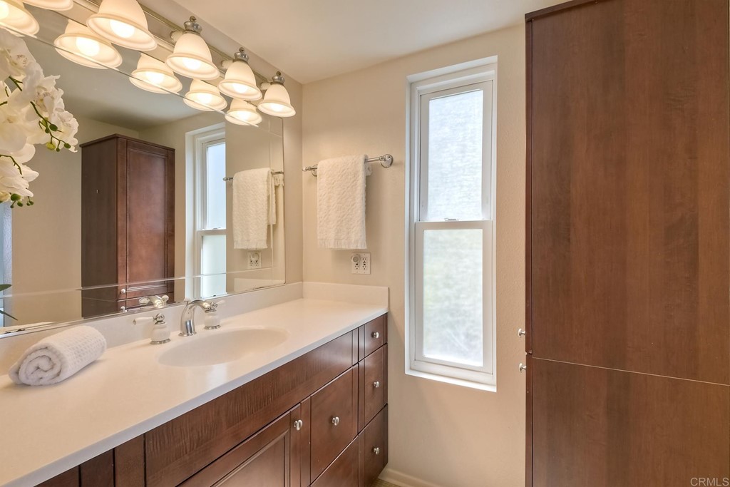 1808 Parliament Road Encinitas, CA 92024 - Photo 24 of 49 a bathroom with a double vanity sink and a mirror