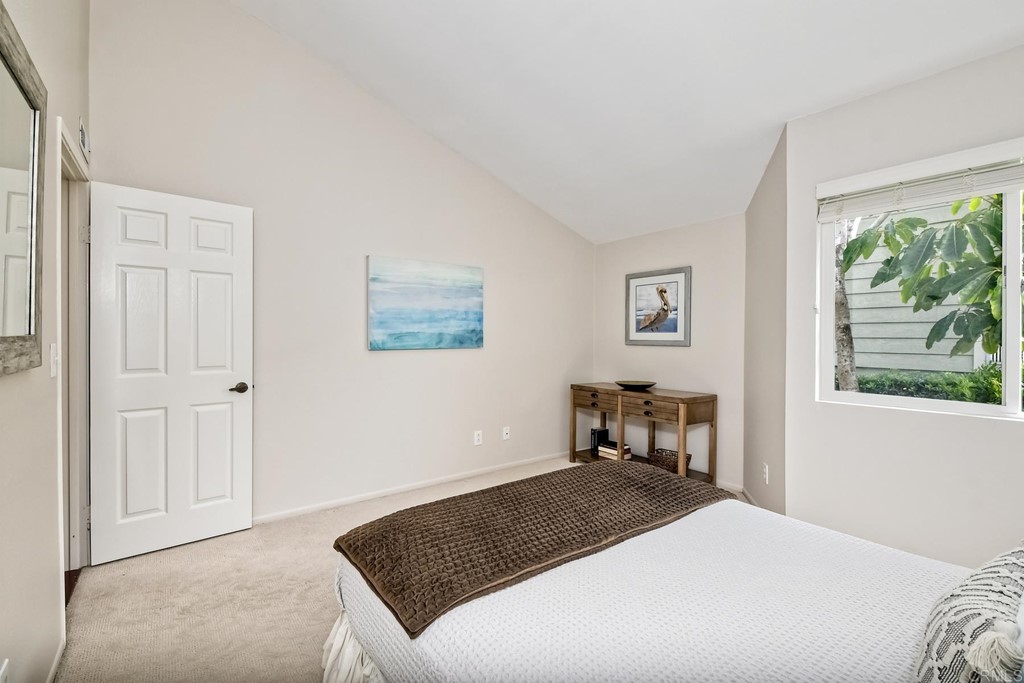 1808 Parliament Road Encinitas, CA 92024 - Photo 30 of 49 a bedroom with a bed and a window