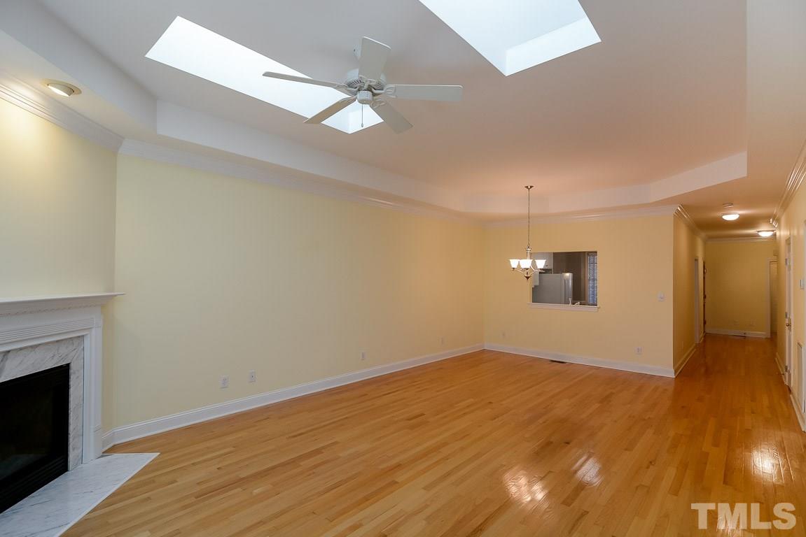 3504 Proprietor Way Raleigh, NC 27612 - Photo 12 of 25 a view of empty room with wooden floor and fireplace