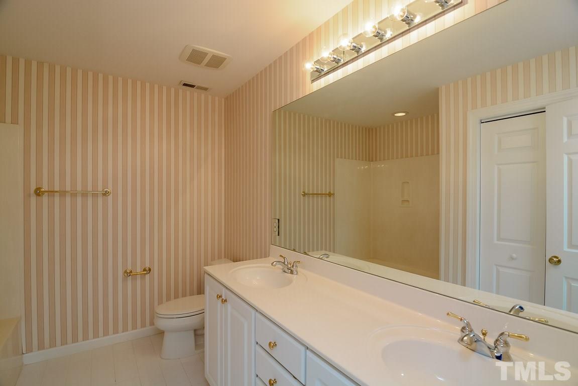 3504 Proprietor Way Raleigh, NC 27612 - Photo 19 of 25 a bathroom with a sink and a mirror