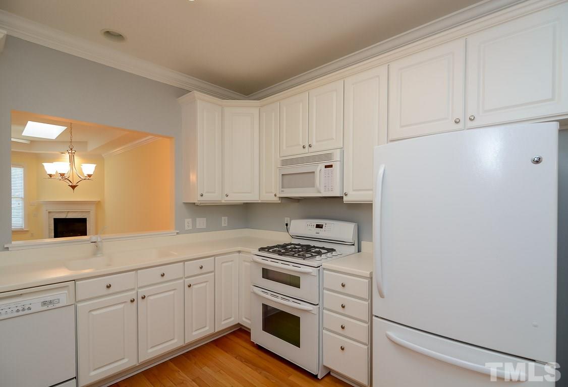 3504 Proprietor Way Raleigh, NC 27612 - Photo 4 of 25 a kitchen with white cabinets and white appliances