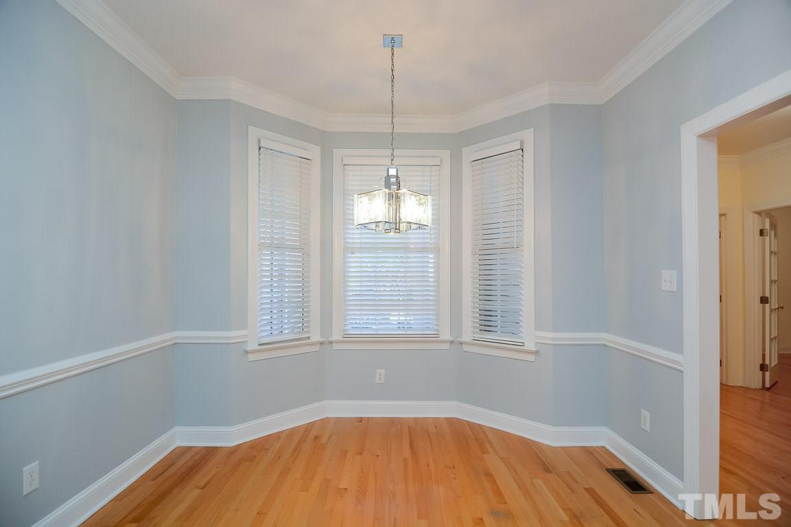 3504 Proprietor Way Raleigh, NC 27612 - Photo 5 of 25 a view of an empty room with wooden floor and a window