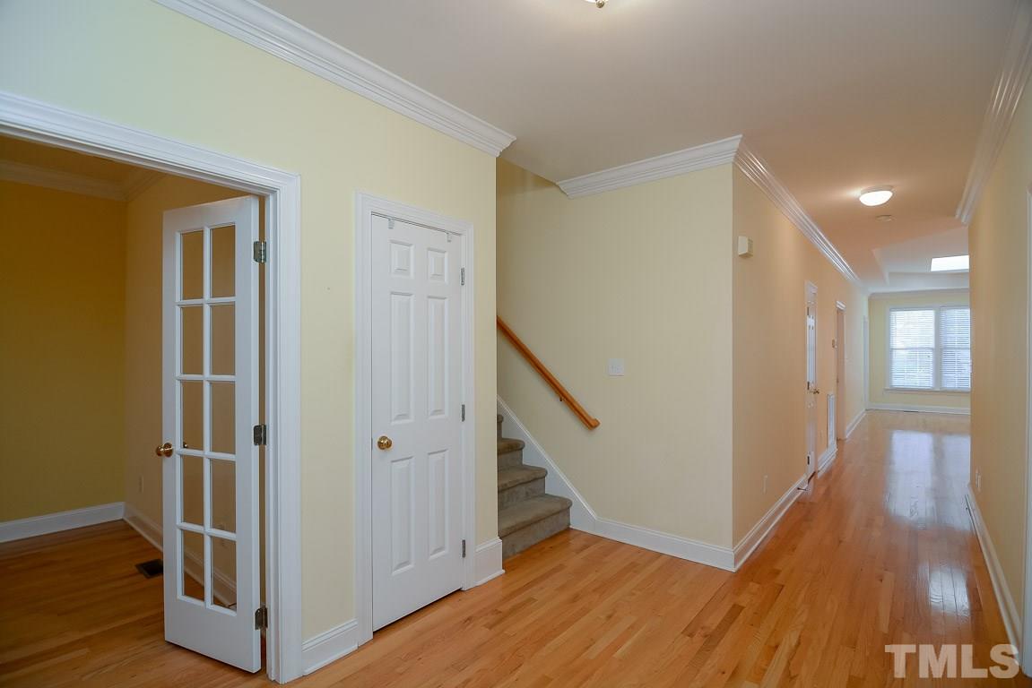 3504 Proprietor Way Raleigh, NC 27612 - Photo 7 of 25 a view of a hallway with wooden floor and stairs