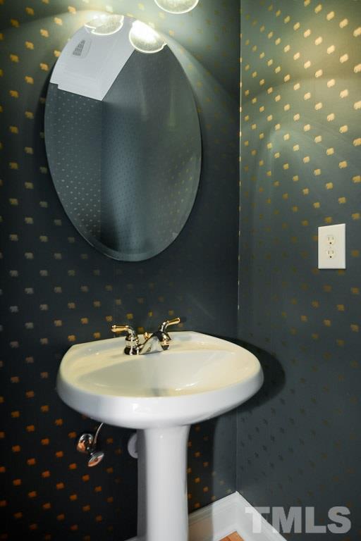 3504 Proprietor Way Raleigh, NC 27612 - Photo 10 of 25 a bathroom with a sink and a mirror