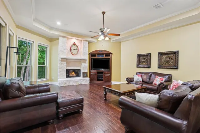 a living room with furniture a fireplace and a flat screen tv