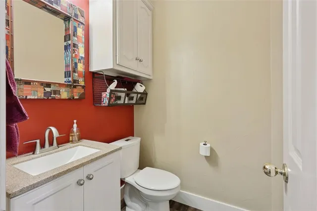 a bathroom with a sink a toilet and a mirror