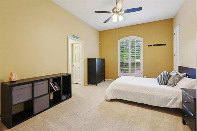 a bedroom with a bed and a flat tv screen