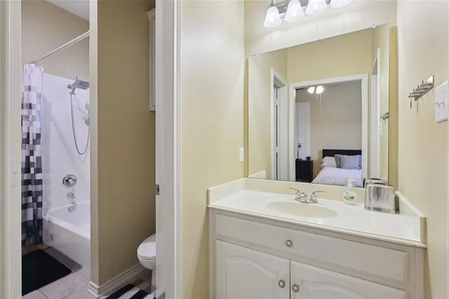 a en suite bathroom with a sink a toilet a shower and a mirror