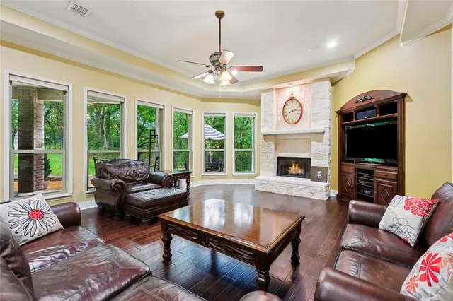 a living room with fireplace furniture and a large window