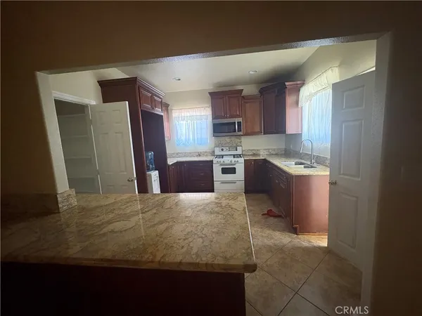 a kitchen with kitchen island sink refrigerator and cabinets
