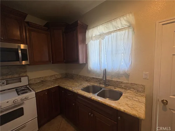 a kitchen with a sink cabinets and stainless steel appliances