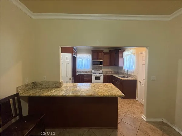 a kitchen with a sink cabinets and wooden floor