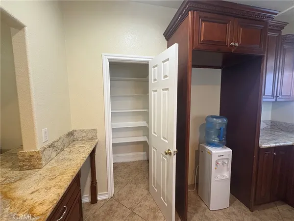 a view of walk in closet and bedroom