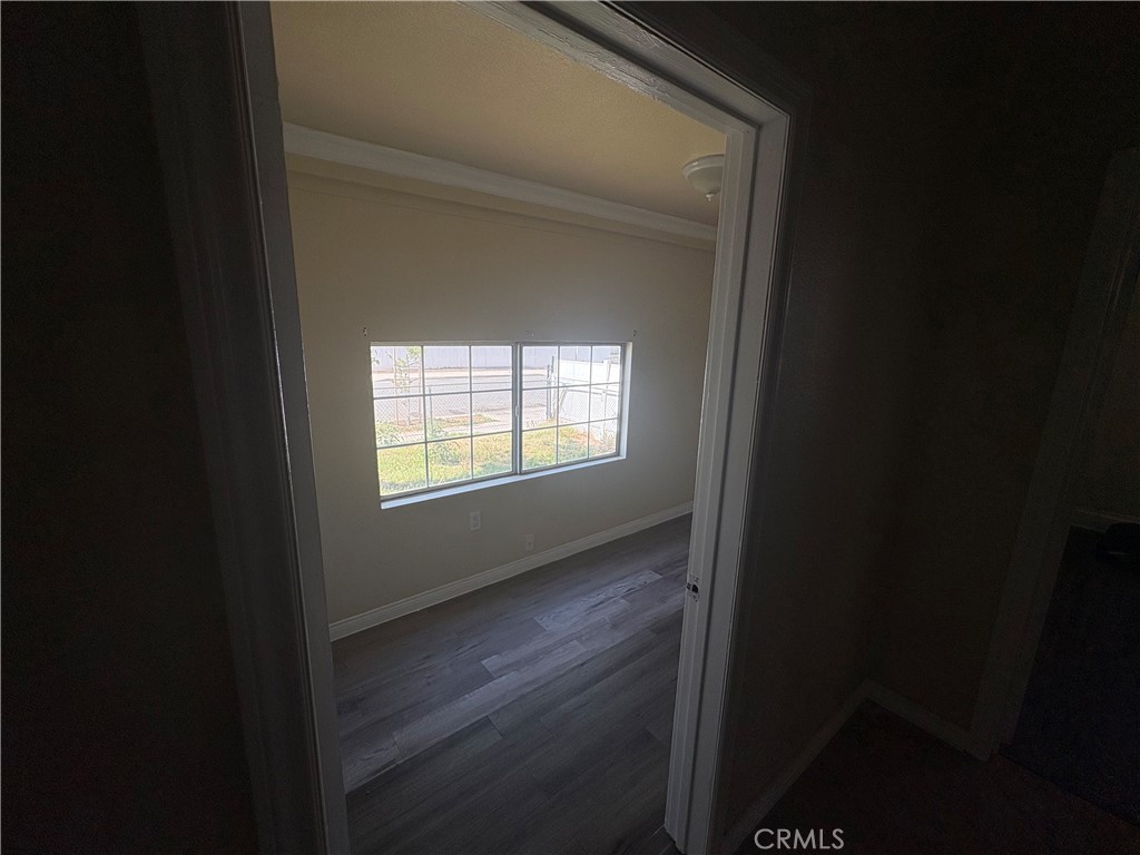 3395 Franklin Avenue Riverside, CA 92507 - Photo 32 of 55 a view of an empty room with wooden floor and a window